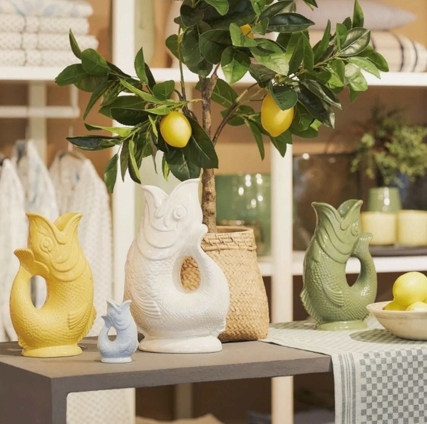 Decorative table setting with ceramic goggle jugs and a lemon tree branch.