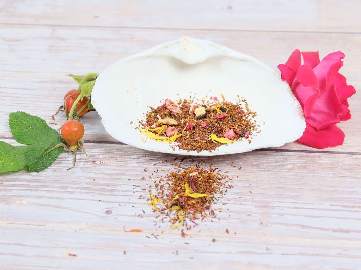 Mother’s Beach Medley Tea blend of flowers and herbs on a white shell with rose hip