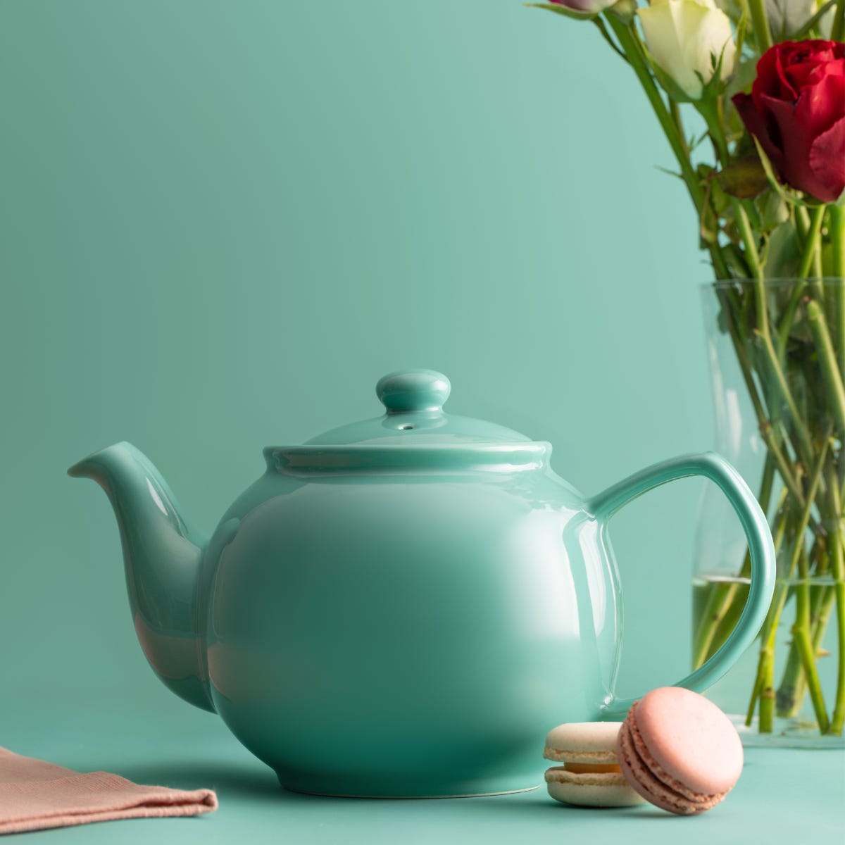 Jade green teapot with green background and flowers