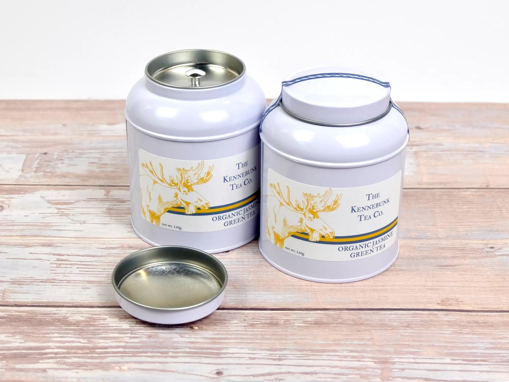 two white tins of jasmine loose leaf tea
