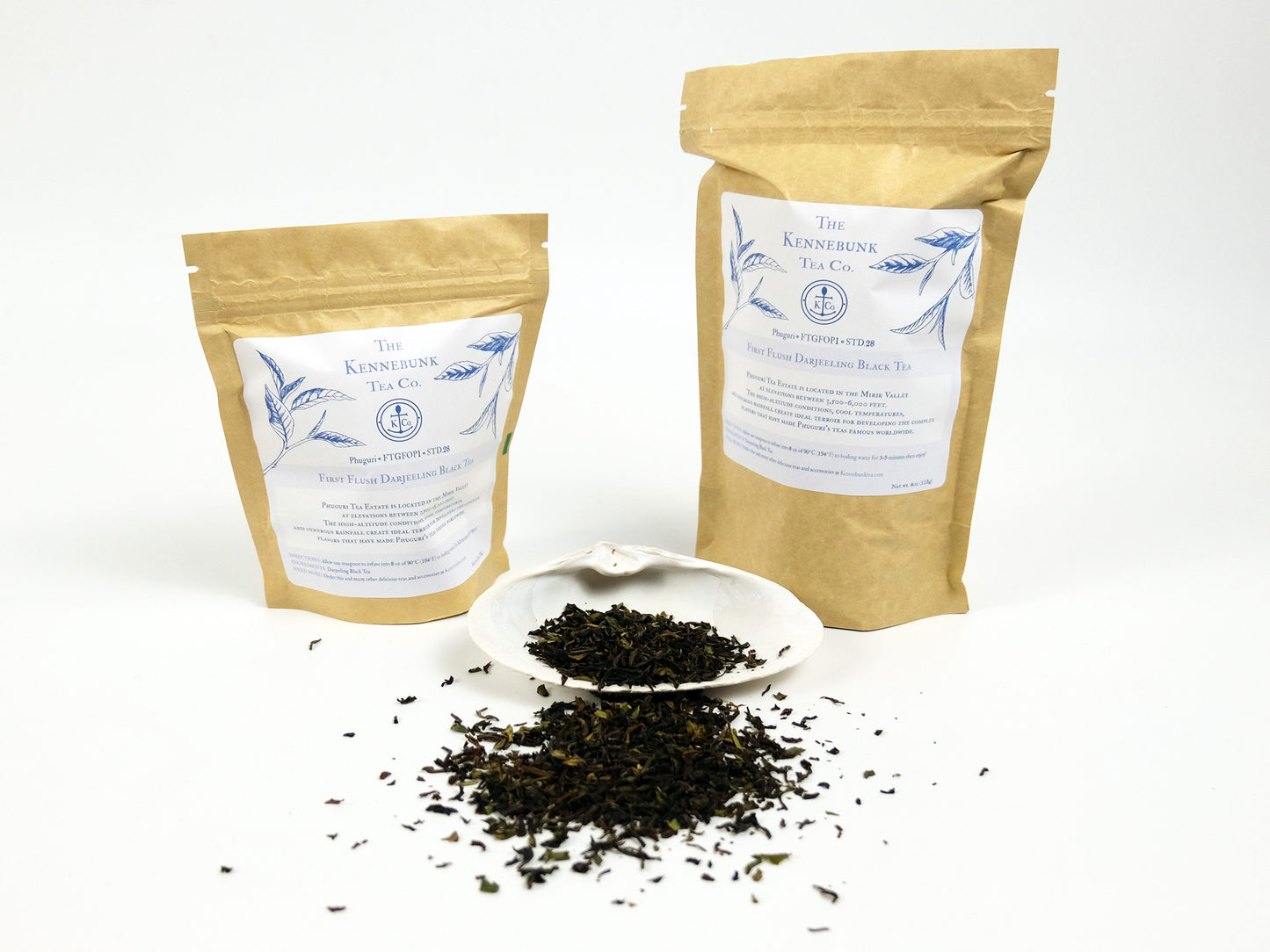 Phuguri first flush Darjeeling loose leaf tea on a white shell with two kraft tea bags