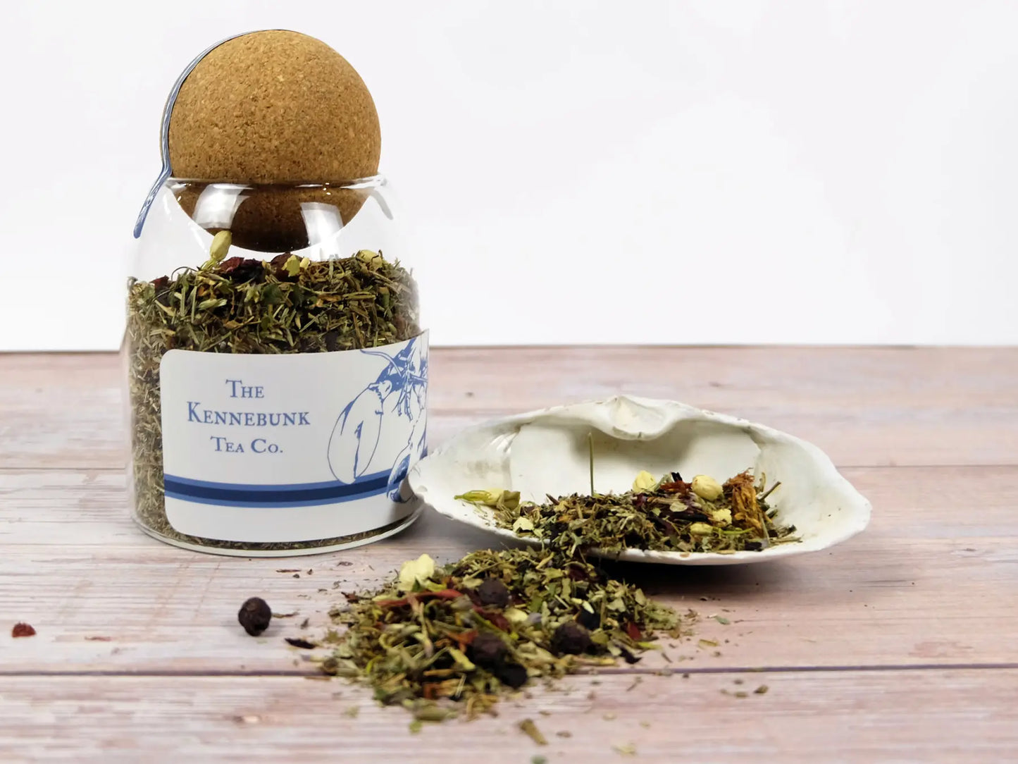 Beauty Tea loose leaf tea in a glass jar next to a white shell, Lobster Label