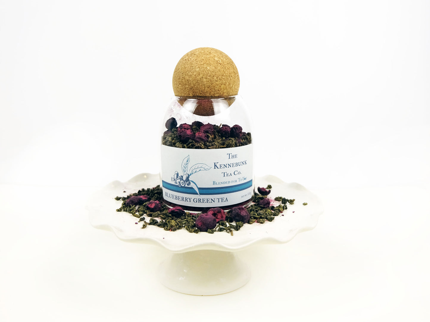 Blueberry Green Tea loose leaf tea in a glass jar on a pedestal
