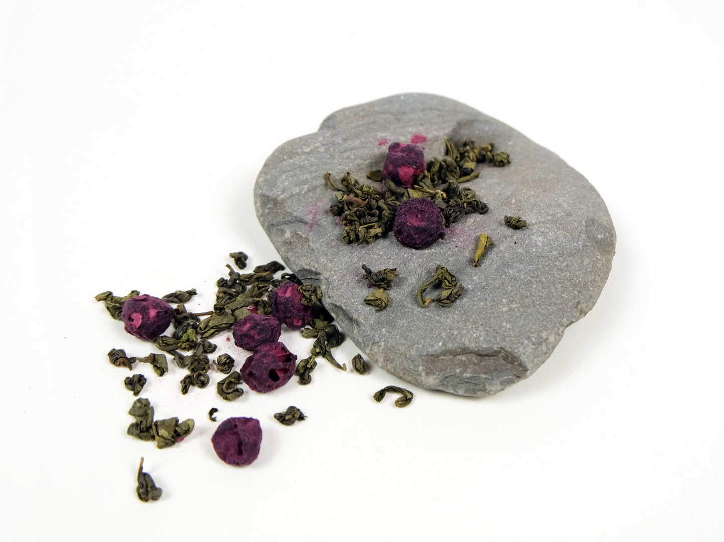 Blueberry Green Tea loose leaf tea spilling over a rock