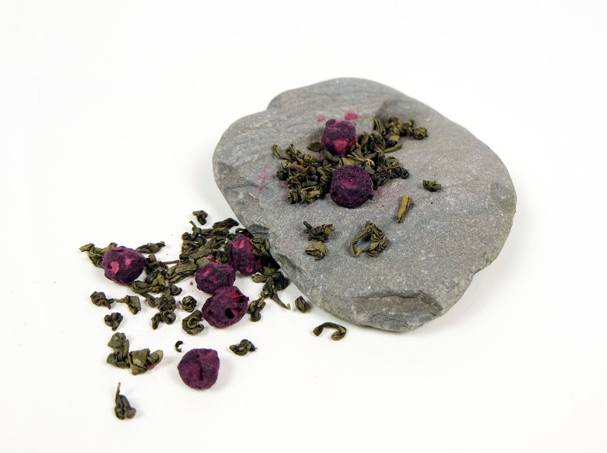 Blueberry Green Tea loose leaf tea spilling over a rock