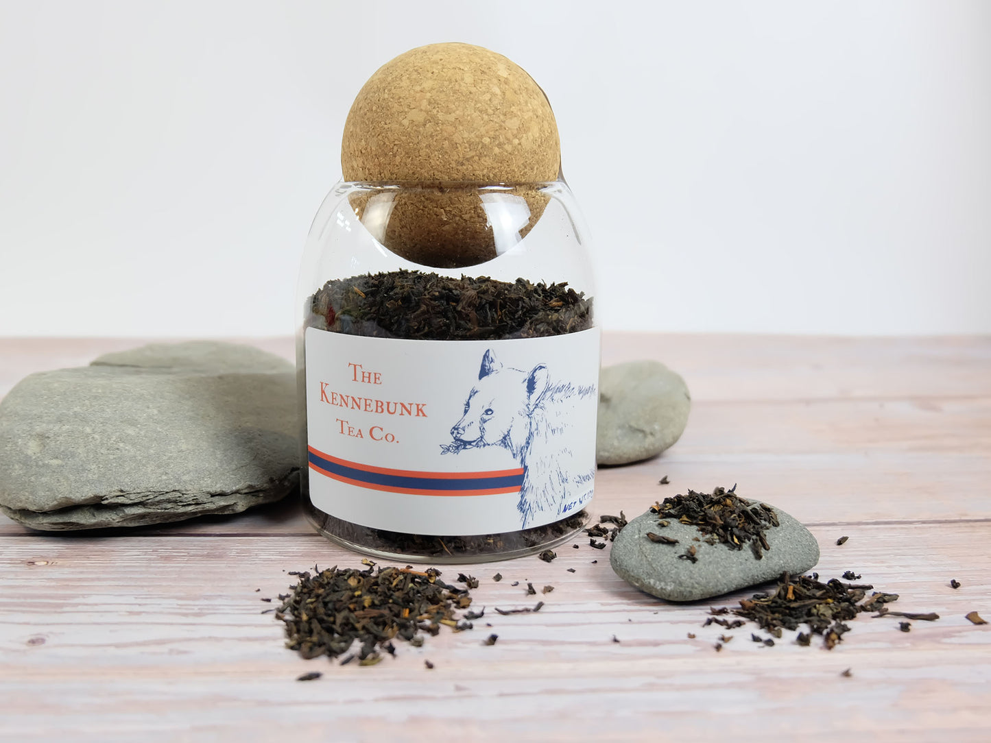 Earl Grey Tea loose leaf tea in a glass jar with Bear label, with rocks around it