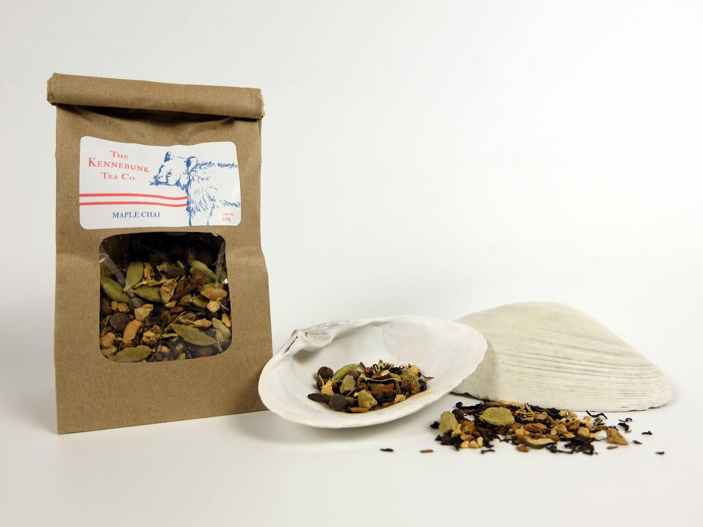 Maple Chai loose leaf tea with one refill tea bag and a white shell with tea behind