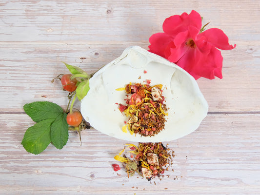 Mother’s Beach Medley Tea blend of flowers and herbs on a white shell, featuring beach rose blossom and rose hips