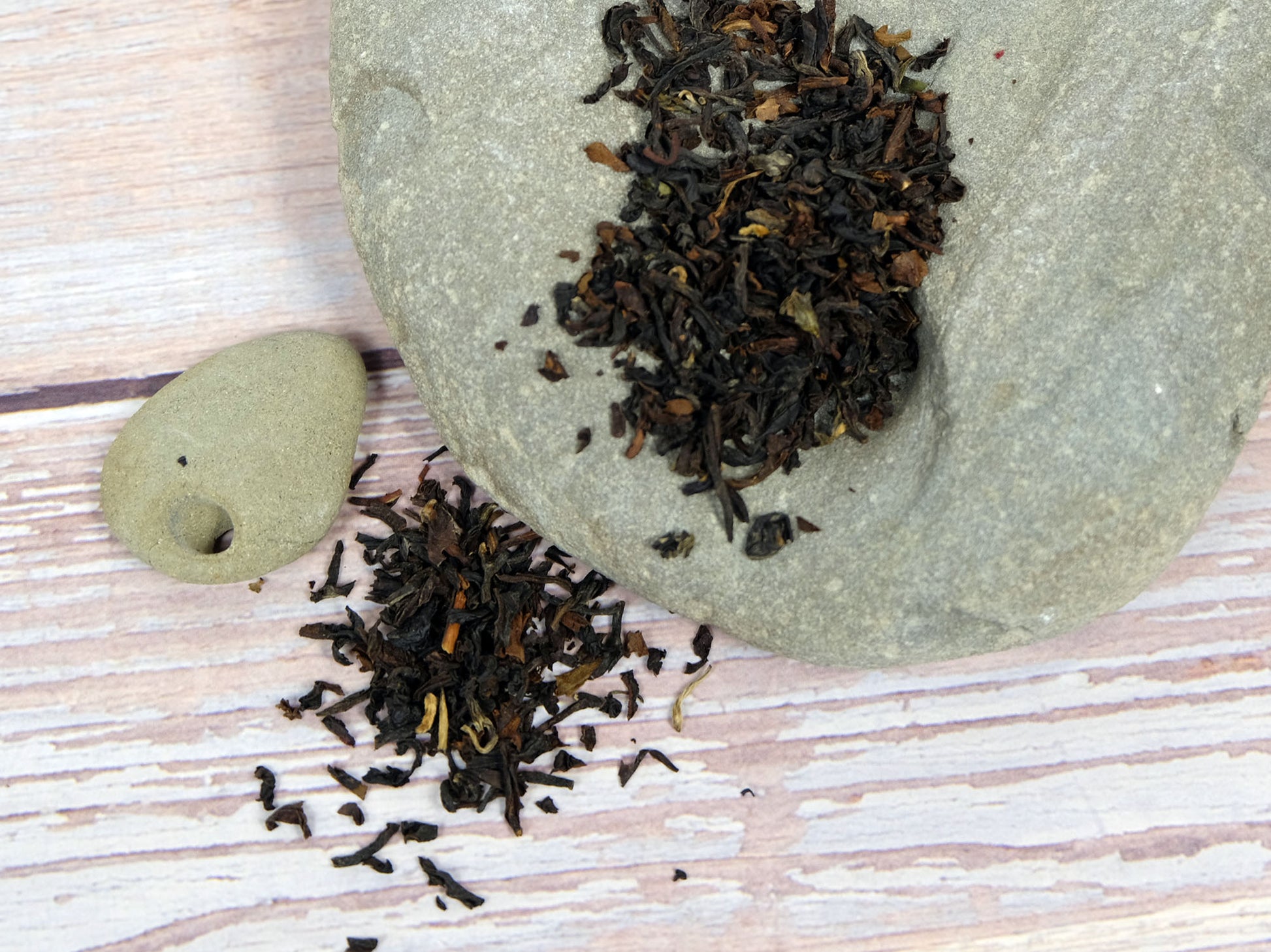Organic Darjeeling Tea loose leaf tea spread over rocks