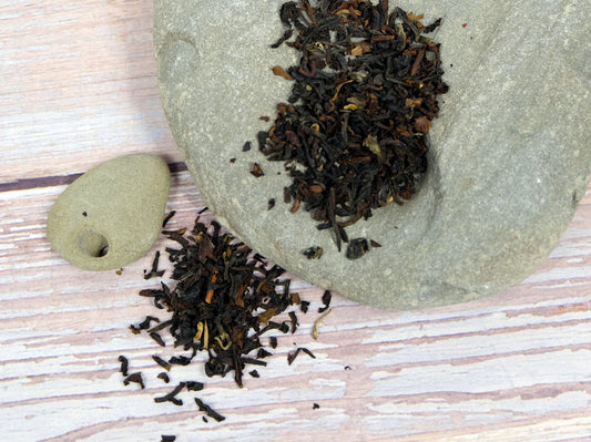 Organic Darjeeling Tea loose leaf tea spread over rocks