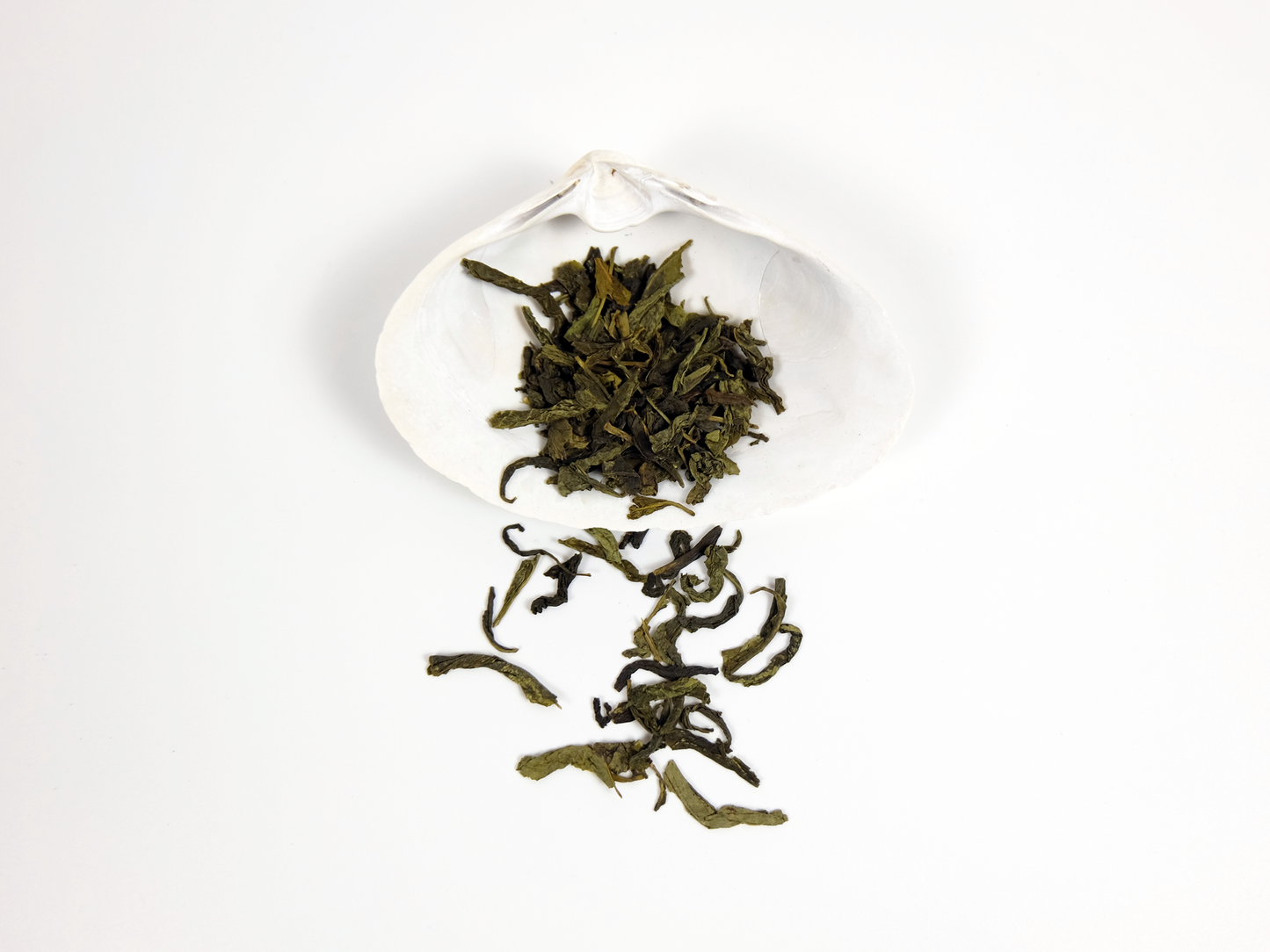 Organic Dragon Well Tea loose leaf tea on a white shell