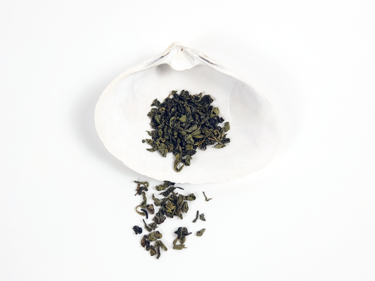 Organic Gunpowder Green Tea loose leaf tea on a white shell