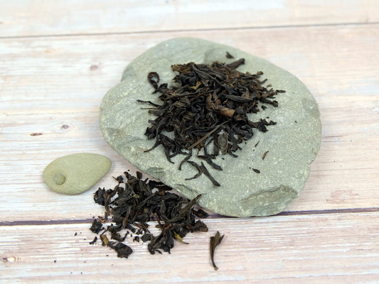 Organic Oolong loose leaf tea spilling over rocks