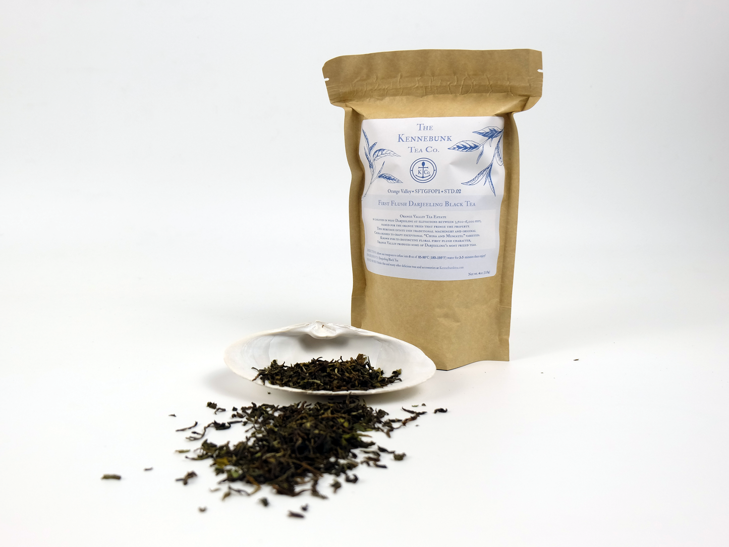 Orange Valley first flush Darjeeling loose leaf tea on a white shell with 4oz kraft tea bag