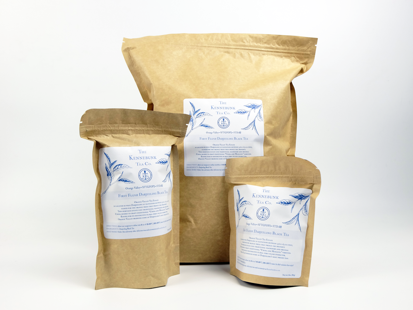 Orange Valley fist flush Darjeeling loose leaf in three different-sized kraft tea bags behind