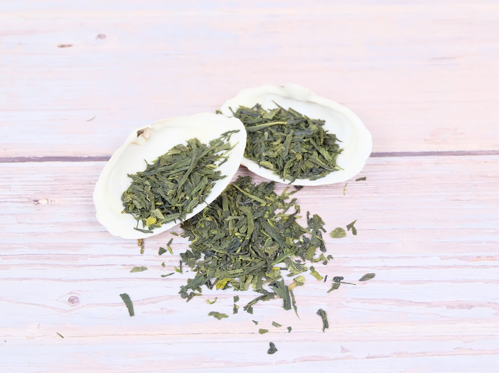 Sencha Green Tea loose leaf tea displayed on two white shells
