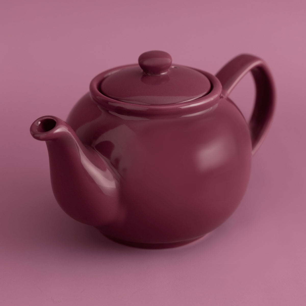 Magenta teapot on a matching pink background